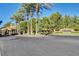 Serene community entrance featuring stone signage, palm trees, and lush landscaping at 10965 Ladyburn Ct, Las Vegas, NV 89141