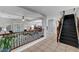 Spacious entryway featuring tile floors, dark wood staircase, and views of the living and dining areas at 10965 Ladyburn Ct, Las Vegas, NV 89141