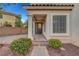 Home's front entry shows a covered porch with decorative columns, a stained glass front door, and brick pathway at 10965 Ladyburn Ct, Las Vegas, NV 89141