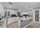 Bright kitchen features white cabinets, granite countertops, stainless steel appliances, and a functional center island at 10965 Ladyburn Ct, Las Vegas, NV 89141