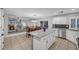 Bright kitchen overlooks the eat-in dining area and living room, and includes granite countertops, stainless appliances, and white cabinets at 10965 Ladyburn Ct, Las Vegas, NV 89141