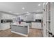 Updated kitchen featuring a central island, granite counters, stainless steel appliances, and tile floors at 10965 Ladyburn Ct, Las Vegas, NV 89141