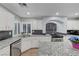 This bright kitchen features white cabinets, granite countertops, tile backsplash and stainless steel appliances at 10965 Ladyburn Ct, Las Vegas, NV 89141