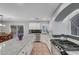 The kitchen features granite countertops, stainless steel appliances, white cabinets, tile backsplash and an eat-in dining area at 10965 Ladyburn Ct, Las Vegas, NV 89141