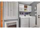 Well-organized laundry room boasts cabinetry, washer, dryer, and additional storage at 10965 Ladyburn Ct, Las Vegas, NV 89141