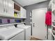 Well-organized laundry room boasts cabinetry, washer, dryer, and access to the outside at 10965 Ladyburn Ct, Las Vegas, NV 89141