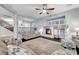 Well-lit living room featuring a fireplace, ceiling fan, hardwood floors, and views of the staircase at 10965 Ladyburn Ct, Las Vegas, NV 89141