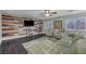 Cozy living room with dark floors, accent wall, green sofa, ceiling fan, and area rug at 10965 Ladyburn Ct, Las Vegas, NV 89141