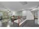 Open living room with dark floors, green sofa, ceiling fan, and staircase at 10965 Ladyburn Ct, Las Vegas, NV 89141