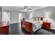 Spacious main bedroom featuring dark wood floors, a ceiling fan, and ensuite bath access at 10965 Ladyburn Ct, Las Vegas, NV 89141