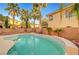 Backyard features refreshing pool, mature palm trees, and desert landscaping at 10965 Ladyburn Ct, Las Vegas, NV 89141