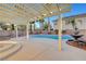 Inviting outdoor space with pool, fountain, palm trees, and patio cover at 10965 Ladyburn Ct, Las Vegas, NV 89141