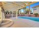 Inviting outdoor space with pool, palm trees, patio cover, and desert landscaping at 10965 Ladyburn Ct, Las Vegas, NV 89141