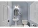 This powder room features white fixtures, and neutral paint, as well as a stylish round mirror and window with shutters at 10965 Ladyburn Ct, Las Vegas, NV 89141