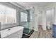 Bathroom showcasing a modern tub and shower with glass doors at 11016 Meadow Leaf Ave, Las Vegas, NV 89144