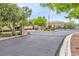 Community entrance with brick pillars and manicured landscaping, offering a secure welcome at 11016 Meadow Leaf Ave, Las Vegas, NV 89144
