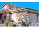 Two-story home featuring a red tile roof, neutral stucco exterior, and a two-car garage at 11016 Meadow Leaf Ave, Las Vegas, NV 89144