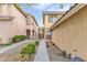 View of exterior elevation with tile roof, desert landscaping, and narrow walkway at 11016 Meadow Leaf Ave, Las Vegas, NV 89144