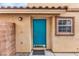 Charming home exterior with a vibrant turquoise front door and decorative accents at 11016 Meadow Leaf Ave, Las Vegas, NV 89144