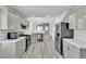 Modern kitchen with stainless steel appliances, light gray cabinets, and hardwood floors at 11016 Meadow Leaf Ave, Las Vegas, NV 89144