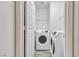 This laundry room is equipped with a modern washer and dryer and convenient shelving at 11016 Meadow Leaf Ave, Las Vegas, NV 89144