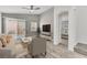 Living room with contemporary furniture, sliding glass doors to patio and view to main bedroom at 11016 Meadow Leaf Ave, Las Vegas, NV 89144