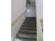 Carpeted staircase featuring a sturdy handrail, offering a safe and stylish transition between floors at 11016 Meadow Leaf Ave, Las Vegas, NV 89144