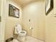 Neutral powder room featuring tiled floors, artwork and modern fixtures at 135 E Harmon Ave # 2916, Las Vegas, NV 89109