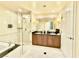Elegant bathroom featuring double sinks, a glass-enclosed shower, and a soaking tub at 135 E Harmon Ave # 2916, Las Vegas, NV 89109