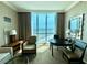 Bedroom features large windows with city views, comfortable seating and desk at 135 E Harmon Ave # 2916, Las Vegas, NV 89109