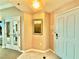 Hallway with beige walls, tiled flooring, a painting, and access to a bedroom with seating at 135 E Harmon Ave # 2916, Las Vegas, NV 89109