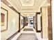 Hotel hallway featuring dark wood accents, neutral walls, carpet accents and decorative lighting at 135 E Harmon Ave # 2916, Las Vegas, NV 89109