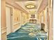 Hotel hallway with blue patterned carpet, a decorative table, and elevator access on either side at 135 E Harmon Ave # 2916, Las Vegas, NV 89109