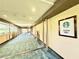 Hallway in Tower I with floor-to-ceiling windows providing natural light and planters at 135 E Harmon Ave # 2916, Las Vegas, NV 89109