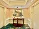 Hotel hallway features patterned carpet, a decorative table with lamps, and elevator access at 135 E Harmon Ave # 2916, Las Vegas, NV 89109