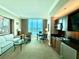Open-concept room boasts large windows, sitting area, kitchenette, and comfortable furnishings at 135 E Harmon Ave # 2916, Las Vegas, NV 89109