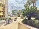 Outdoor patio with decorative bushes, trees, tables, and chairs perfect for enjoying a relaxing day outside at 135 E Harmon Ave # 2916, Las Vegas, NV 89109