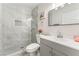 This bathroom has marble style tile in the shower, a modern vanity, and a toilet at 1437 Price St, Henderson, NV 89011