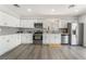 Modern kitchen with white cabinets, stainless steel appliances, and a stylish backsplash at 1437 Price St, Henderson, NV 89011