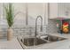 Modern kitchen sink with stylish faucet, white countertops, and elegant backsplash at 1437 Price St, Henderson, NV 89011