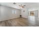 Bright living room with hardwood floors, ceiling fan, and a view into the backyard at 1437 Price St, Henderson, NV 89011