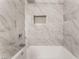 Close-up of the shower with a built in shelf and shower head at 1437 Price St, Henderson, NV 89011