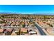 Suburban homes displaying trees and green spaces in the surrounding landscape with city skyline in the distance at 1803 Eagle Village Ave, Henderson, NV 89012