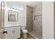 Modern bathroom with a tiled shower, stylish fixtures, vanity mirror, and plenty of natural light, offering comfort and style at 1803 Eagle Village Ave, Henderson, NV 89012