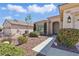 Inviting home exterior with desert landscaping, featuring a covered entry and well-maintained shrubs for curb appeal at 1803 Eagle Village Ave, Henderson, NV 89012