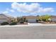 Charming single-story home with a well-manicured front yard, mature shrubs, and a wide driveway leading to a two-car garage at 1803 Eagle Village Ave, Henderson, NV 89012