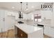 Modern kitchen features white cabinets, stainless steel appliances, and a spacious center island, perfect for culinary enthusiasts at 1803 Eagle Village Ave, Henderson, NV 89012
