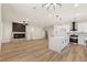 Bright open-concept living space with modern fireplace and a gourmet kitchen with island at 1803 Eagle Village Ave, Henderson, NV 89012