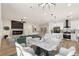 A great open living space flows from the fireplace to the dining area and into the kitchen with modern appliances at 1803 Eagle Village Ave, Henderson, NV 89012