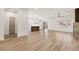Open floor plan with wood flooring, connecting living spaces and kitchen, creates a spacious and airy atmosphere for modern living at 1803 Eagle Village Ave, Henderson, NV 89012